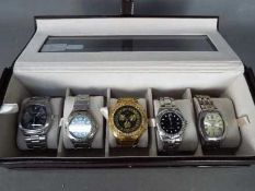 A watch display box containing five wrist watches