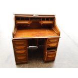 A roll top bureau, tambour top enclosing fitted interior, approximately 118 cm x 106 cm x 78 cm,