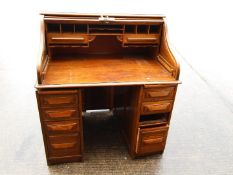 A roll top bureau, tambour top enclosing fitted interior, approximately 118 cm x 106 cm x 78 cm,