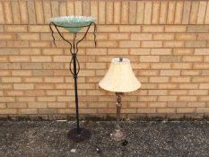 A decorative table lamp, 85 cm (h) and a glass bowl on wrought iron stand, 115 cm (h).