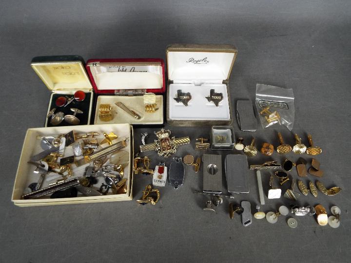 A collection vintage cufflinks, tie clips and similar.