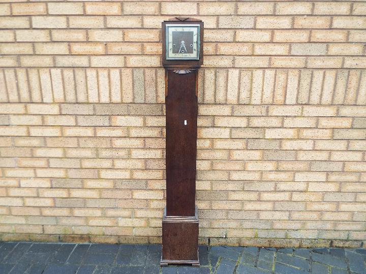 An oak cased Enfield granddaughter clock with pendulum,