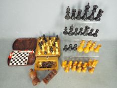 Two loose chess sets, the larger with 9 cm king and two travelling sets.