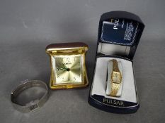 Two lady's wristwatches, an Equenta and a Pulsar (boxed) and a travel alarm clock.