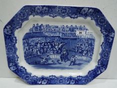 Blue and white meat dish with scene of "Fighting Cocks". People placing wagers and spectators.