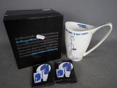Sir Roger Moore - A 'Whatever It Takes' mug with artwork designed by Sir Roger Moore,