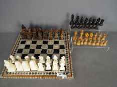 Two chess sets, one with Egyptian style pieces (10 cm king),
