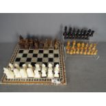 Two chess sets, one with Egyptian style pieces (10 cm king),