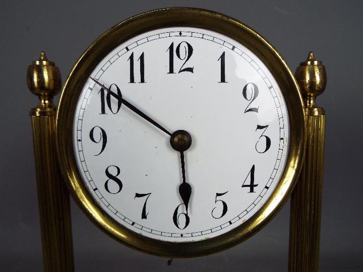 An early 20th century 400-day torsion clock, large 11cm enamel dial, mounted between reeded pillars, - Image 2 of 7