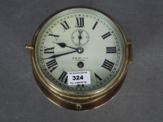 A mid-20th century ships clock, brass case with opening cast brass bezel,