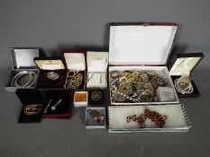 A collection of costume jewellery, necklaces, bangles, brooches, earrings and similar.