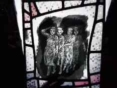 A printed glass panel depicting four ladies, approximately 30 cm x 25 cm.
