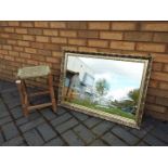 A wall mirror decorated with horse and carriage, approximately 60 cm x 86 cm and a small stool.