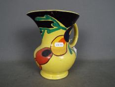 Susie Cooper - A jug with hand painted decoration against a yellow ground, approximately 18.