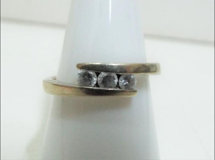 9 ct - A 9ct trilogy ring, set with three cubic zirconia, size O, approximate weight 3.02 grams.