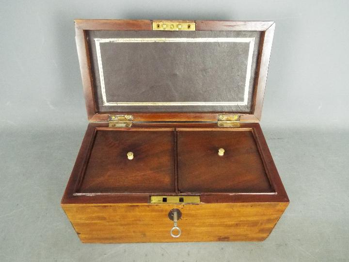 A twin compartment tea caddy of rectangular form, approximately 15 cm x 30 cm x 16 cm.