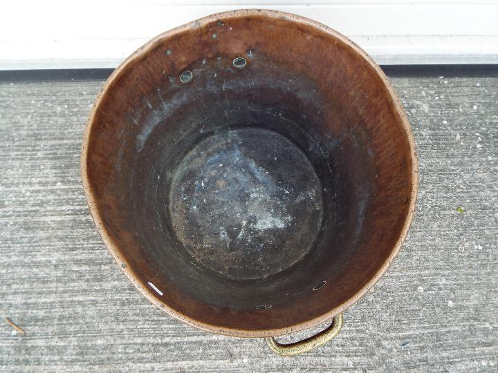 A large copper and brass preserving pan with twin handles, approximately 33 cm (h) x 47 cm (d). - Image 4 of 4