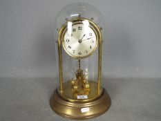 An early 20th century 'ships wheel' model 400-day torsion clock, mounted on a hoop,