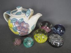 A small collection of paperweights including two Caithness examples and a hand painted Island