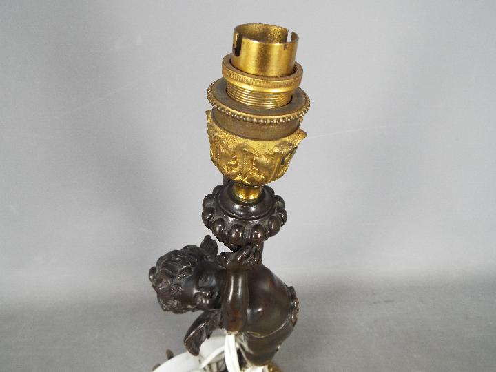 A decorative table lamp in the form of a standing putto, approximately 42 cm (h) including fitting. - Image 4 of 4
