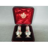 A late Victorian two piece cruet set contained in fitted case, Birmingham assay 1897,