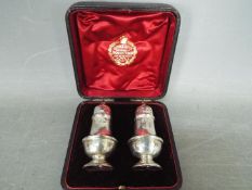 A late Victorian two piece cruet set contained in fitted case, Birmingham assay 1897,
