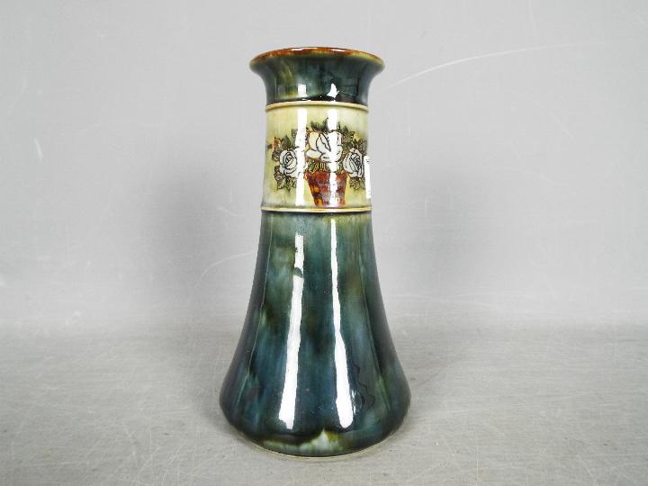 A Royal Doulton stoneware vase of tapered form with floral decoration,