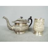 Indian Silver - A tankard and teapot with repoussé decoration,