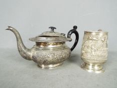 Indian Silver - A tankard and teapot with repoussé decoration,