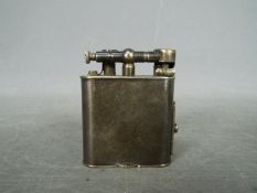 A vintage Dunhill cigarette lighter.