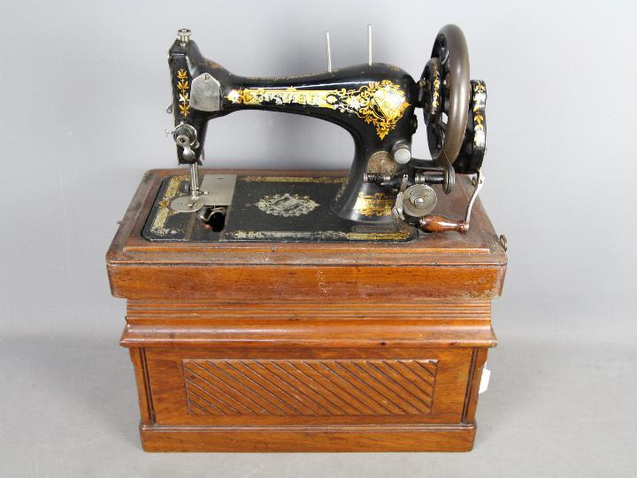 An antique Singer sewing machine in case, serial number 14677197.