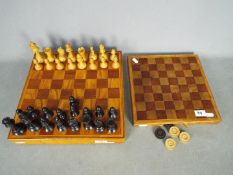 A wooden chess set and board, 9.5 cm king and a draughts board and pieces.
