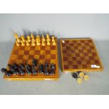 A wooden chess set and board, 9.5 cm king and a draughts board and pieces.