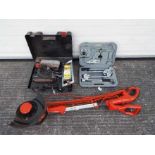 A Flymo Contour 500E garden strimmer, a cased 600 watt Skilsander and similar.