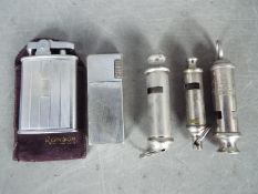 Three vintage whistles to include an ARP and an ACME Guide and two vintage cigarette lighters.