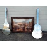 A pair of decorative wall mirrors in the form of acoustic guitars,