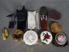 A collection of powder compacts and grooming sets.
