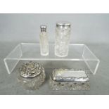 Four silver topped dressing table jars / containers, various assay and date marks.
