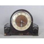 An oak cased mantel clock, Arabic numerals to the dial, with key and pendulum.