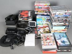A collection of DVD's, a boxed portable DVD player, sat-navs, binoculars and similar.