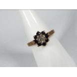 A 9ct yellow gold diamond and sapphire cluster ring, size M, approximately 2.
