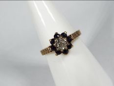 A 9ct yellow gold diamond and sapphire cluster ring, size M, approximately 2.