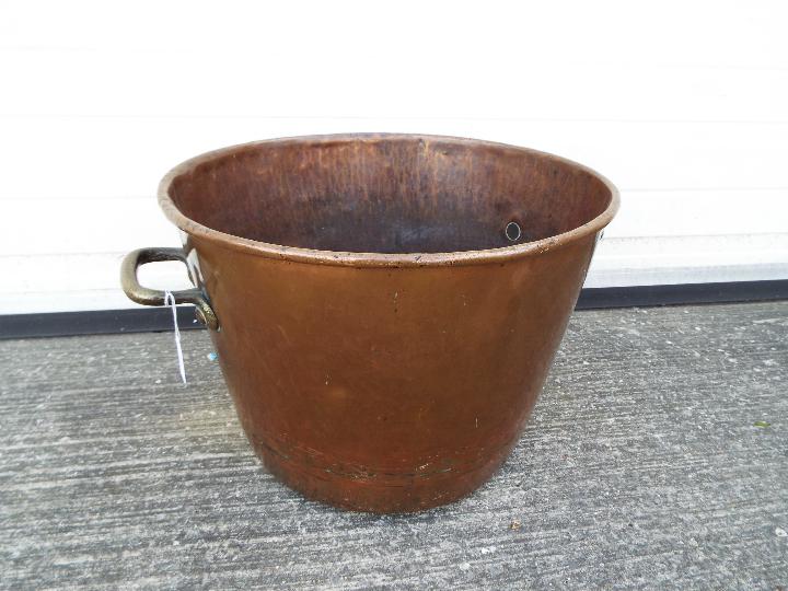 A large copper and brass preserving pan with twin handles, approximately 33 cm (h) x 47 cm (d).