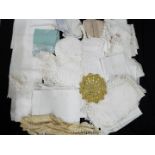 A box of vintage linen, doilies, table ware.