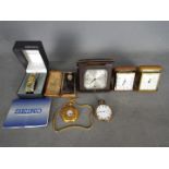 A collection of travel clocks and watches.