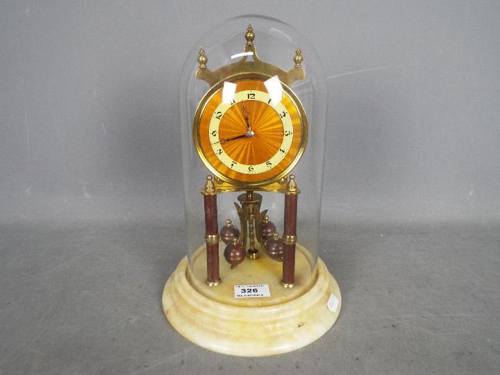 An Art Deco 400-day torsion clock in orange/ bronze lacquer finish,