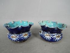 A pair of Doulton Lambeth squat vases with pierced, flared rims, applied floral decoration,