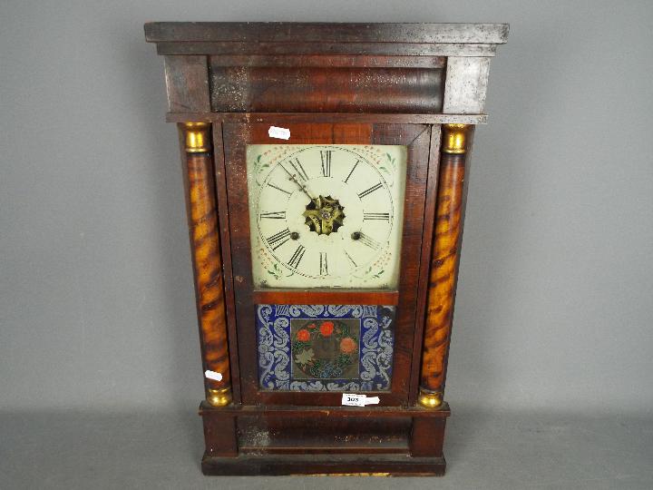 An American 30 hour wall clock by E N Welch, Roman numerals to a white dial.