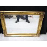 A decorative bevel edged wall mirror, approximately 64 cm x 90 cm.