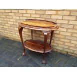 An occasional table with removable butlers tray, on ball and claw supports,